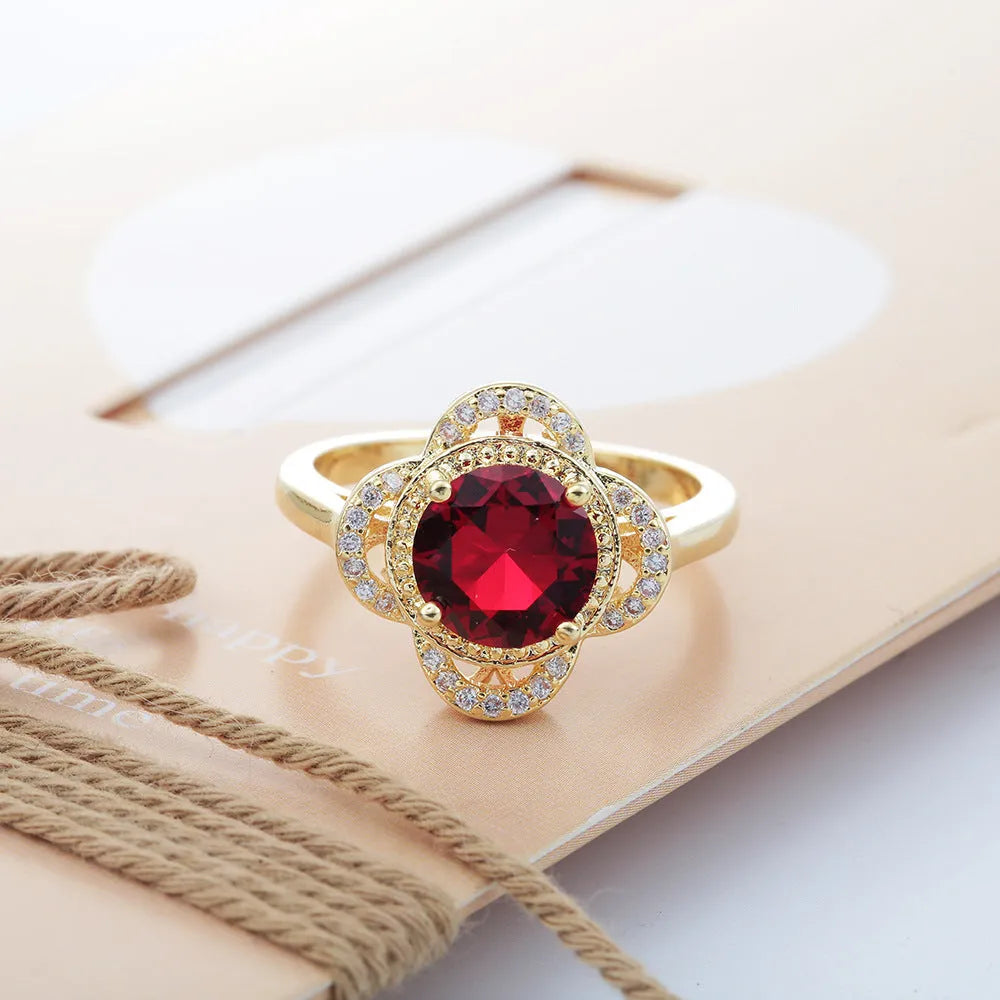 Copper fruit-shaped ring with inlaid zircon gemstones on a model's finger.