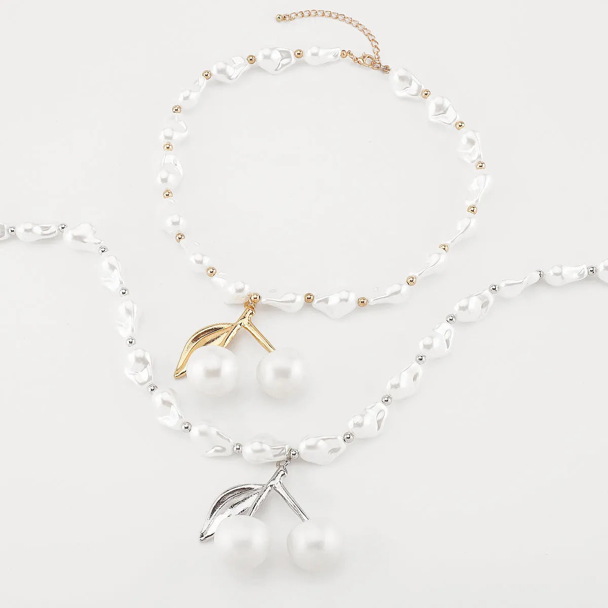Women's creative pearl necklace with geometric fruit pendant in gold or white finish options