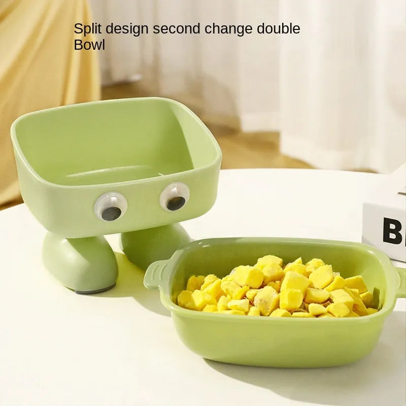 Green cartoon robot shaped elevated cat bowl with a tilted, detachable inner food dish.