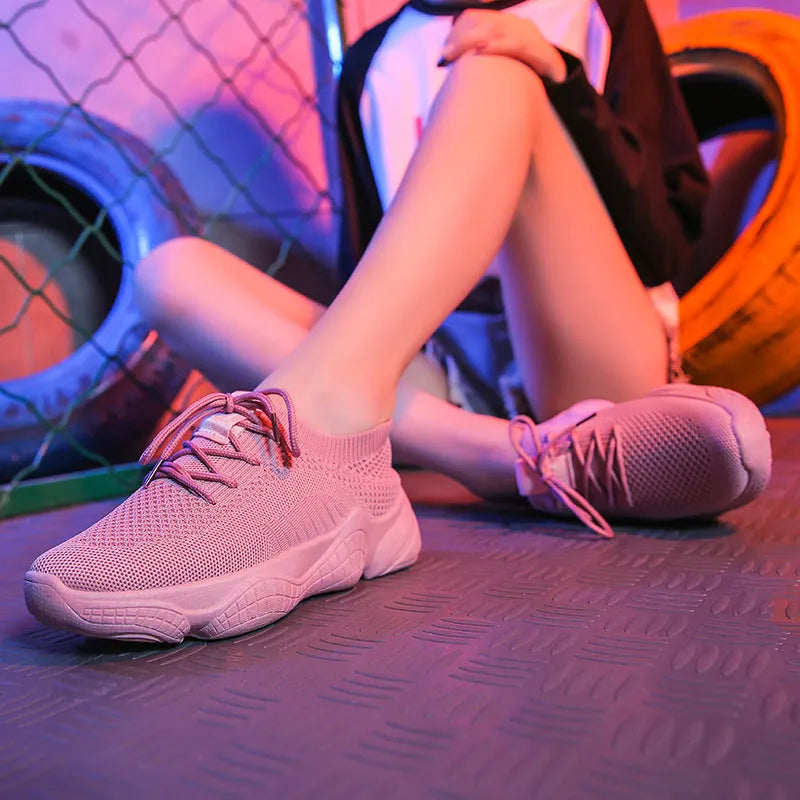 White women's low-top woven sports shoes with thick rubber sole and front strap closure.