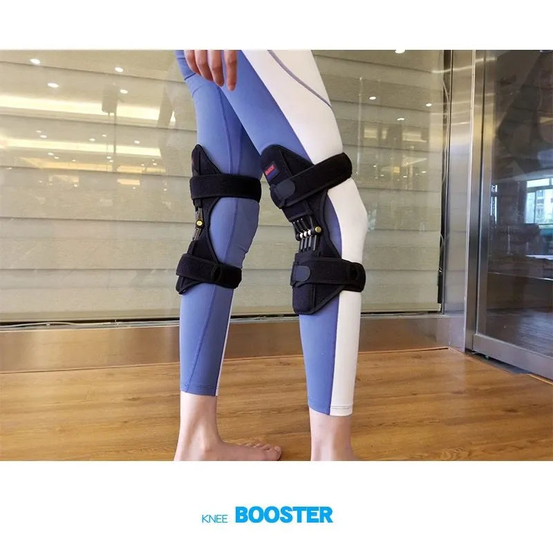 Black spring-loaded knee support brace with adjustable straps and venting holes, shown on a knee.