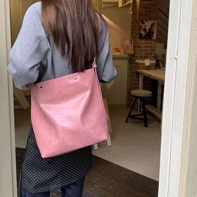 Corduroy one shoulder bag in pink or brown showing 39cm length and spacious interior for commuters