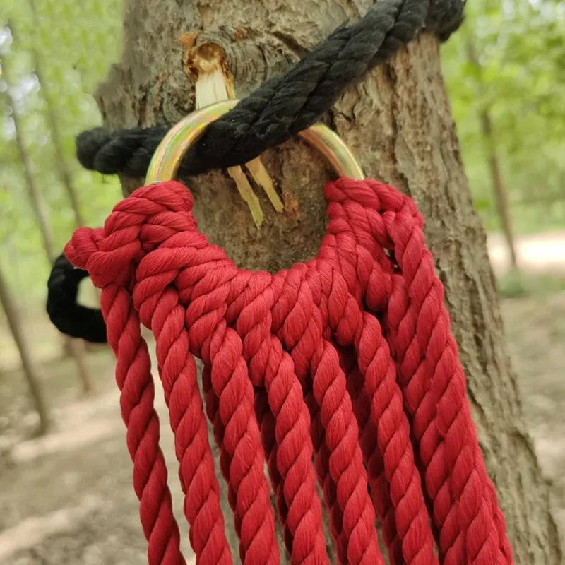 Outdoor nylon rope mesh hammock hung between two trees, showing its 1.1m width and included tying rope.