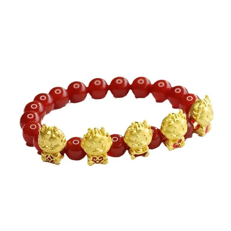 Close-up of a red agate bracelet with a carved five blessing dragon motif on 8mm beads.