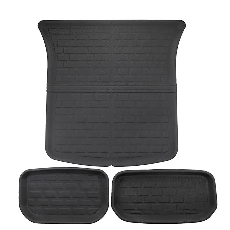 Set of four textured TPR floor mats for a Tesla Model Y, showing foot mats and storage box mats.
