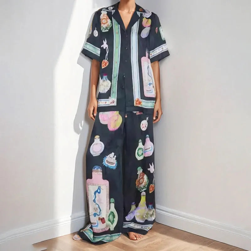 Women's black casual two-piece set with cartoon animation print, cardigan sleeve top, and matching trousers