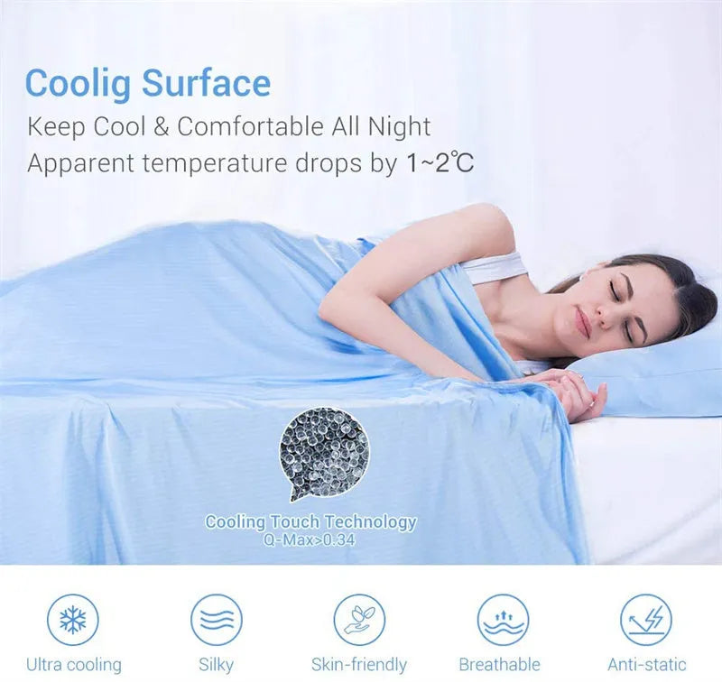 Blue cooling blanket with double-faced texture on a bed, showing its lightweight drape.
