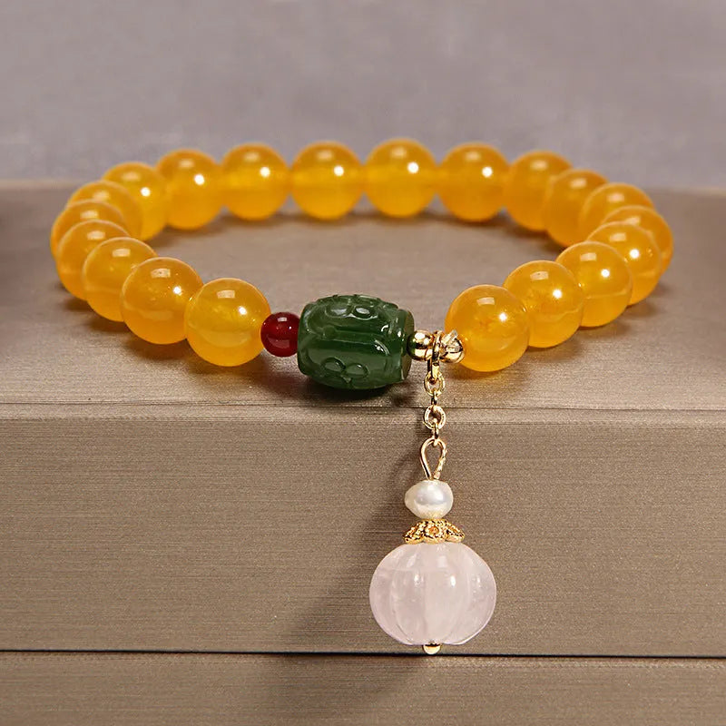 Women's yellow agate crystal bracelet on adjustable gold silk cord.
