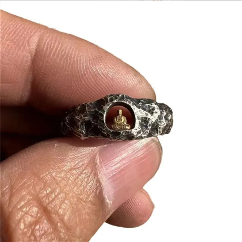 Hand-forged copper Grotto Buddha ring with rock texture on a size 8 finger.