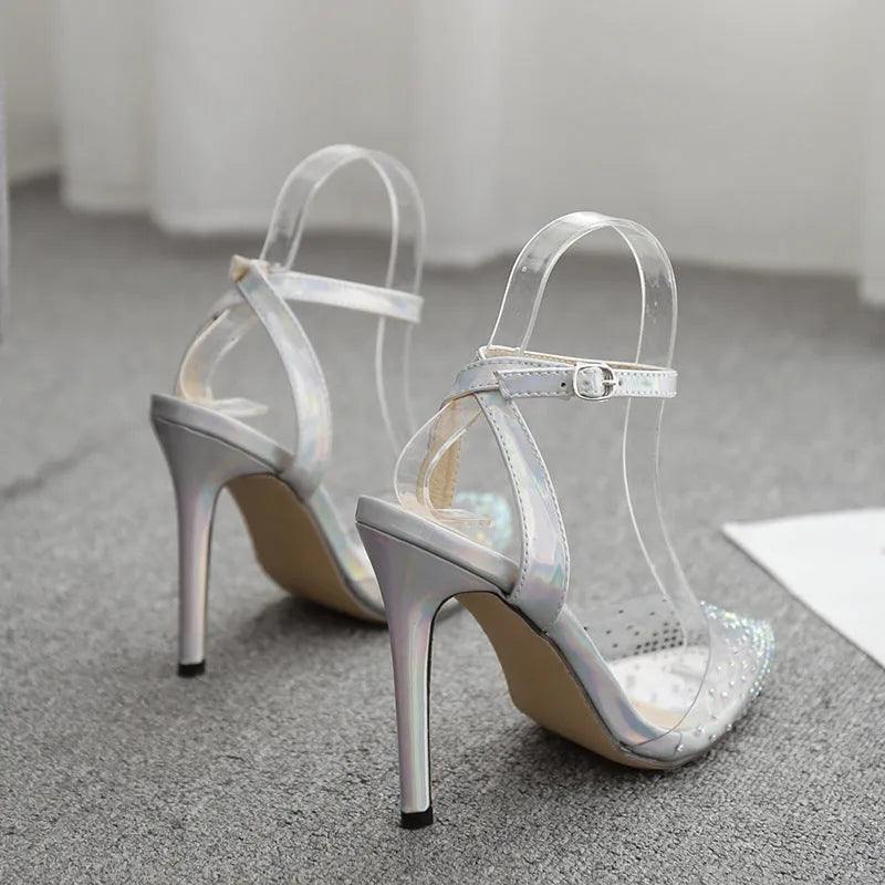 Women's pointed toe stiletto sandals with diamond details on a PVC upper.