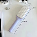 Self-cleaning hair brush with rotating handle in Roland purple colour showing ergonomic plastic design