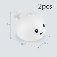 Automatic spray whale bath toy with LED lights floating in water