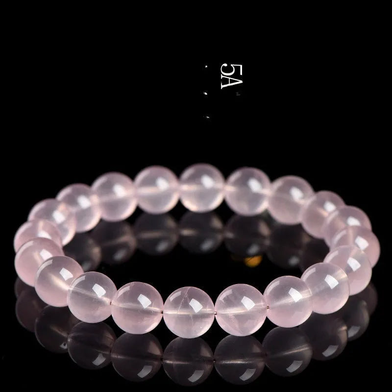 Women's crystal bracelet with round polished beads in pink, showing size options from 6mm to 22mm diameter