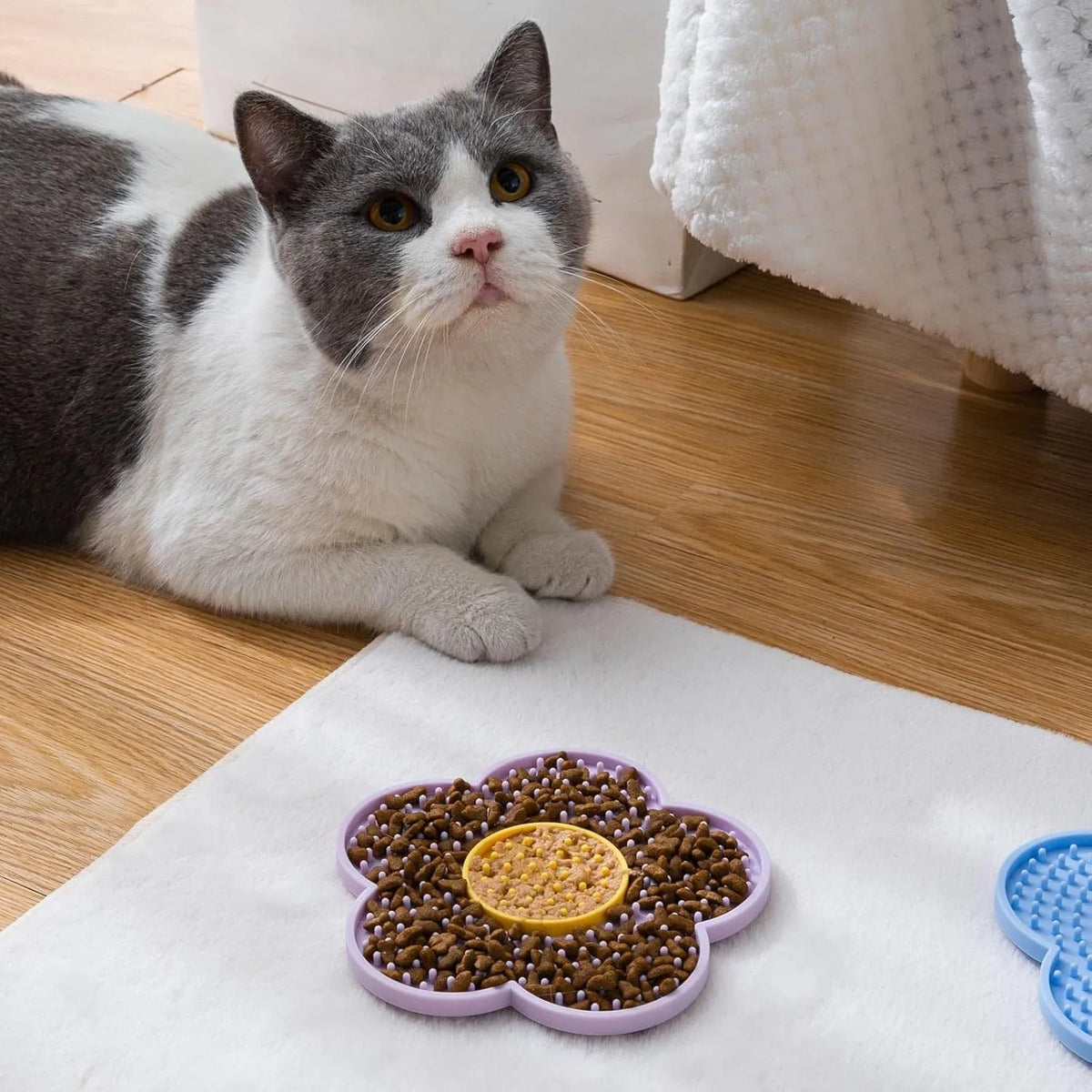 Flower-shaped silicone licking mat for dogs and cats with suction cups on the back.