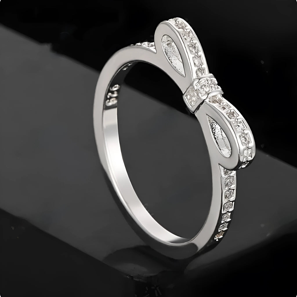 Silver bow-shaped ring with rhinestone zircon crystal decoration on model finger