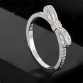 Silver bow-shaped ring with rhinestone zircon crystal decoration on model finger