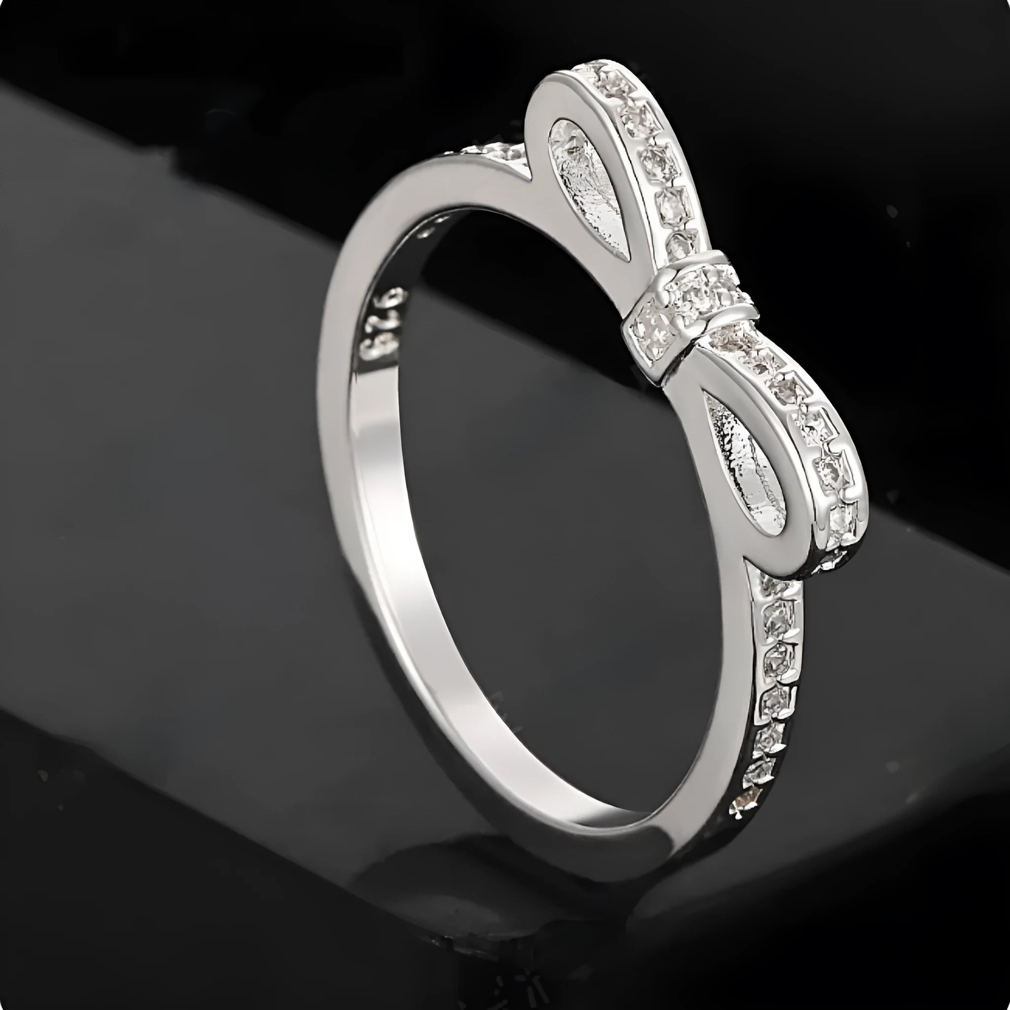 Silver bow-shaped ring with rhinestone zircon crystal decoration on model finger