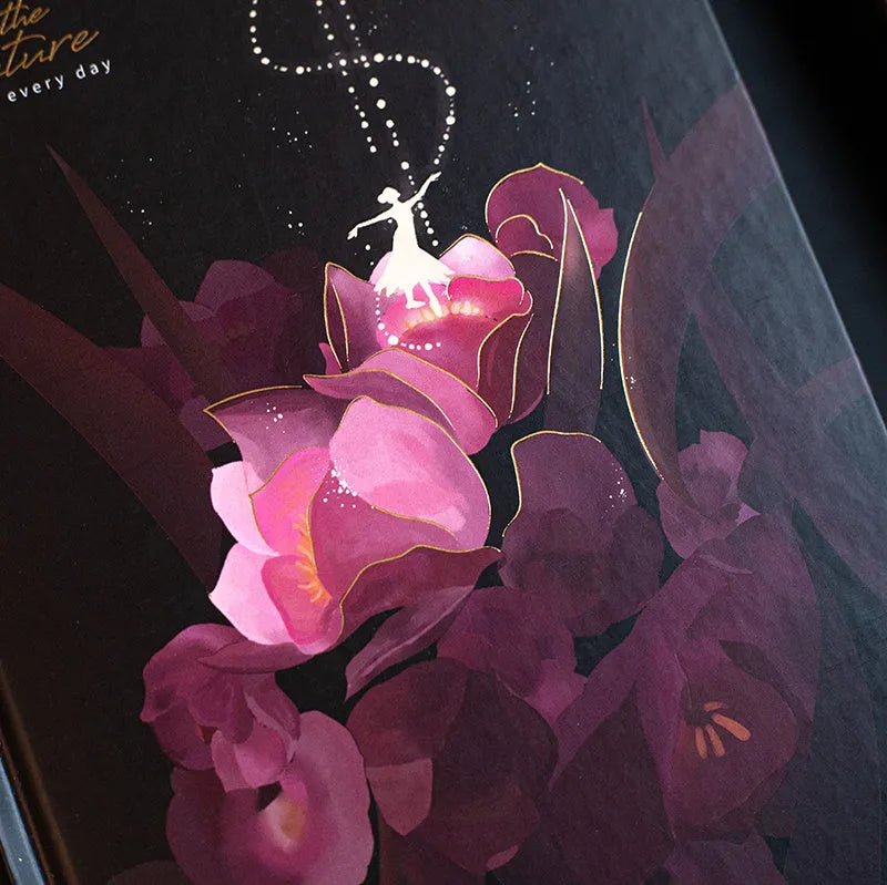A5 diary notebook with luminous holographic cover open to show pages with colour illustrations.
