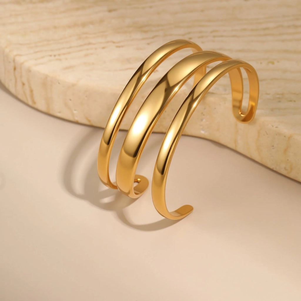 Geometric line stainless steel bracelet for women, showing gold electroplated and natural steel finish options