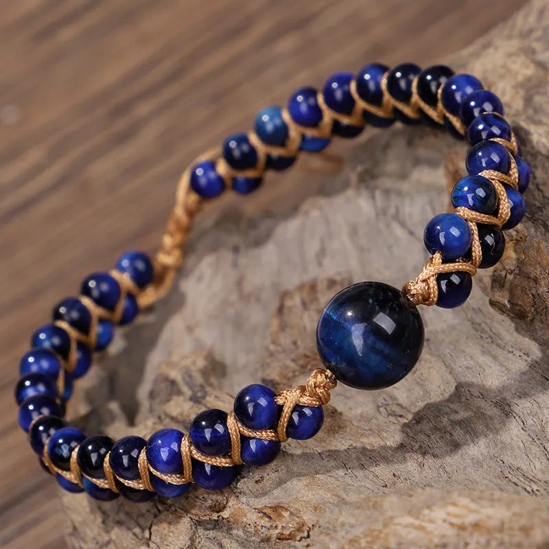 Close-up of a handmade woven pull bracelet with geometric pattern in blue Tigereye stone beads.
