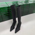 Black pointed toe women's below knee boots with stiletto heel and back zipper.