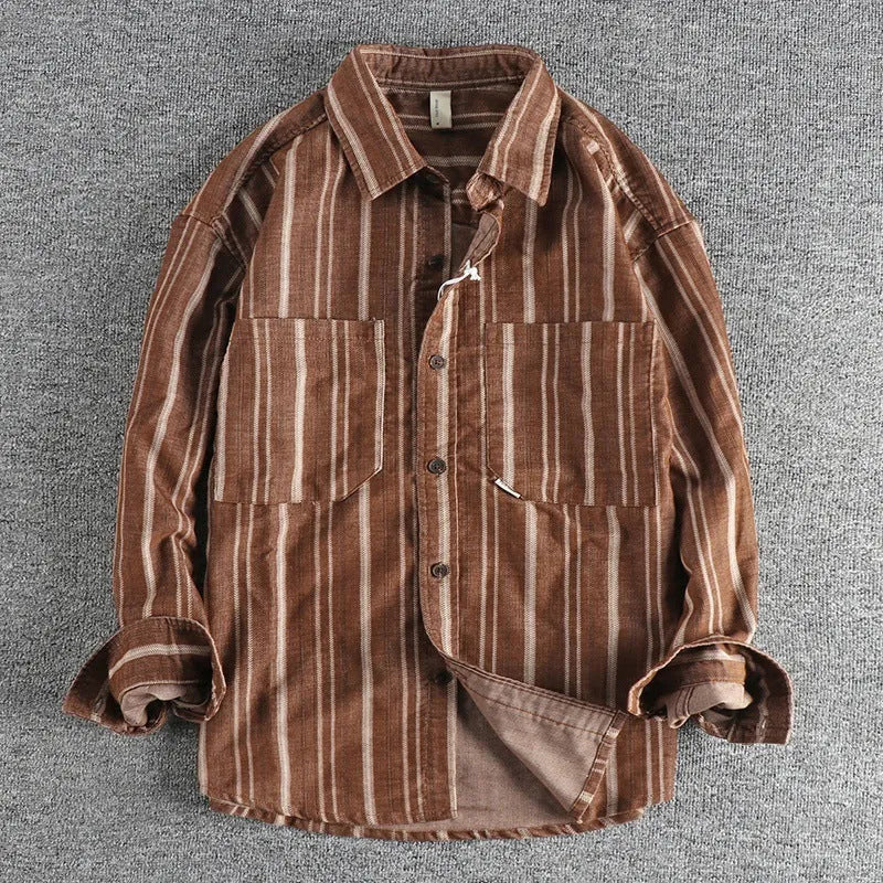 Man modelling a loose-fitting vintage striped shirt in apricot colour with long sleeves, Japanese retro style.