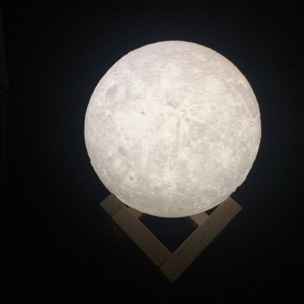 3D printed white moon lamp on a wooden stand with touch control ring at base