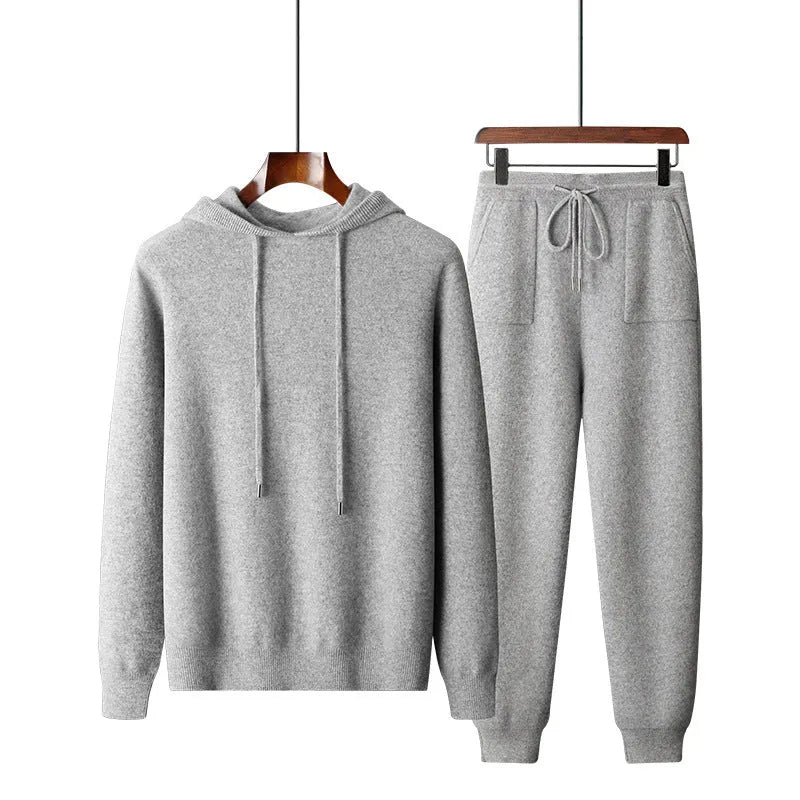 Men's light gray cashmere hoodie and matching trousers laid out as a complete casual two-piece set.