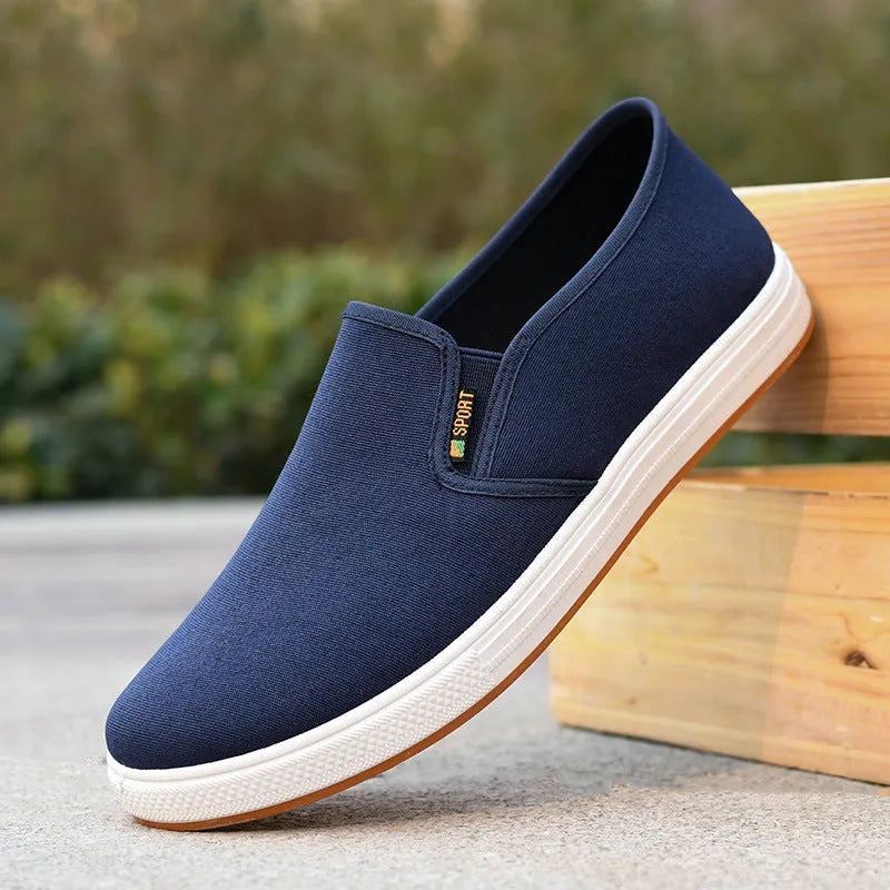 Men's black and blue canvas slip-on shoes with shallow cut design and composite soles