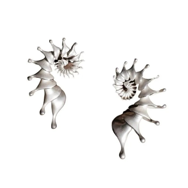 Matte finish conch stud earrings with three-dimensional shaping and irregular design elements