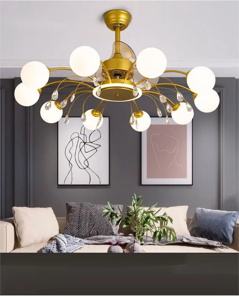 Black and gold ceiling fan light fixture with acrylic shade and metal blades, shown with remote control