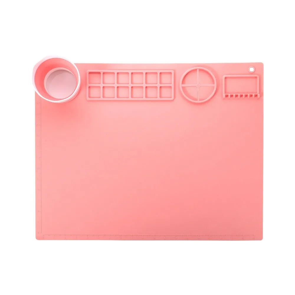 Light blue silicone painting mat with two built-in bowls, sized 50 by 40 centimetres.