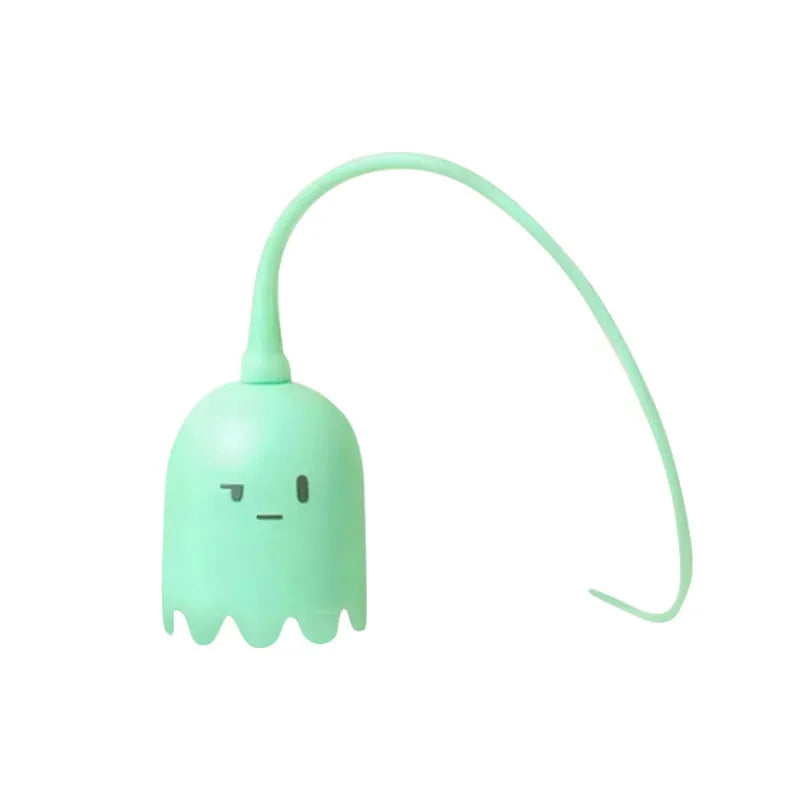 Green automatic electronic cat wand toy with swinging silicone tails on a table