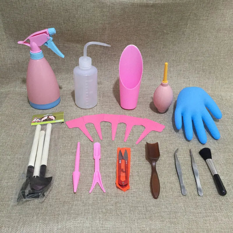 14-piece succulent gardening tool set showing watering can, tweezers, mini shovels, rake, and scissors on a table.