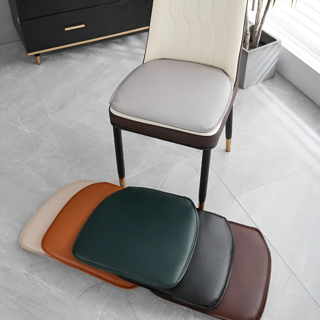 Orange leather horseshoe-shaped seat cushion on a wooden chair showing non-slip base.