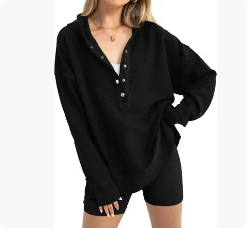 A peacock green women's loose-fit sweater with raglan long sleeves, laid flat.