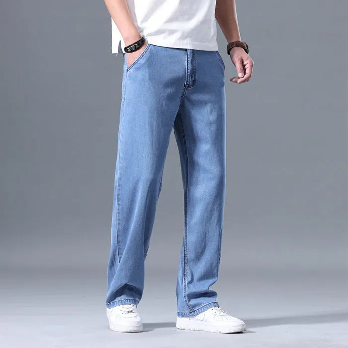 Man wearing loose-fitting straight-leg light blue lyocell jeans.