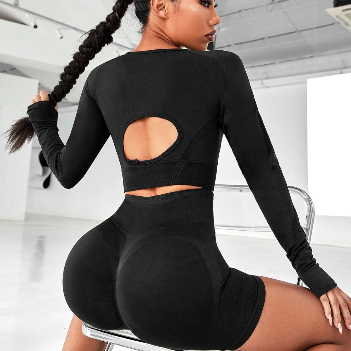 Women's black high-waisted yoga suit with long sleeves and matching trousers