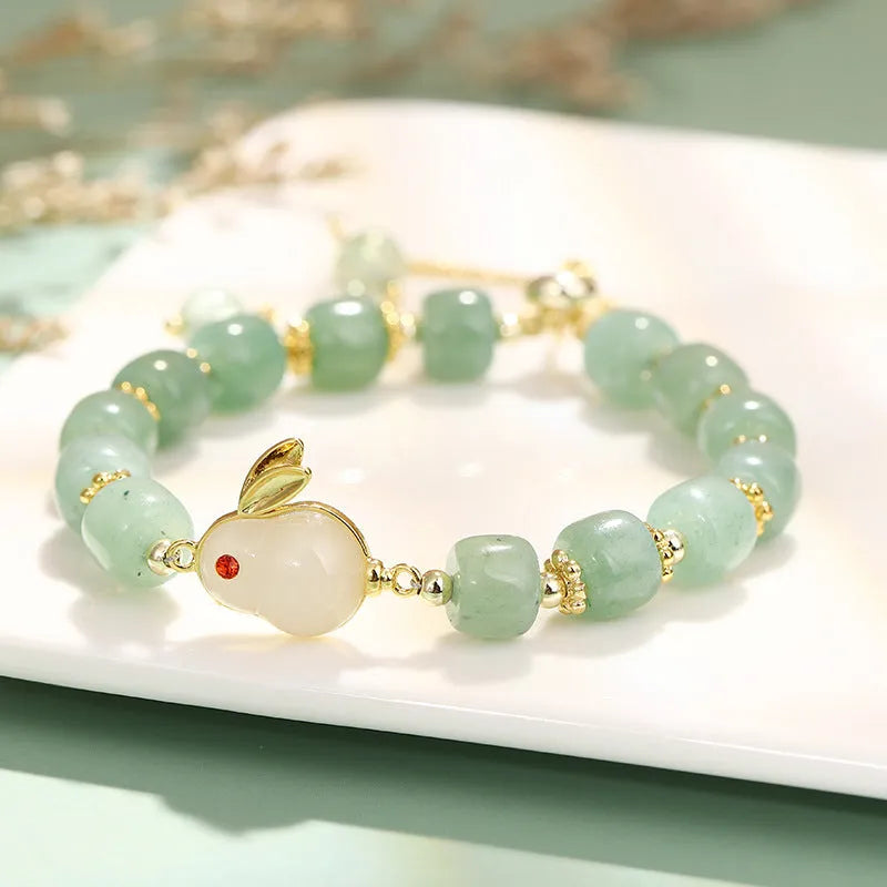 Rabbit charm bracelet with green aventurine and strawberry quartz stones on a gold plated copper chain