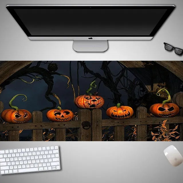 Oversized Halloween-themed gaming mouse pad on a desk, showing non-slip rubber cloth base.