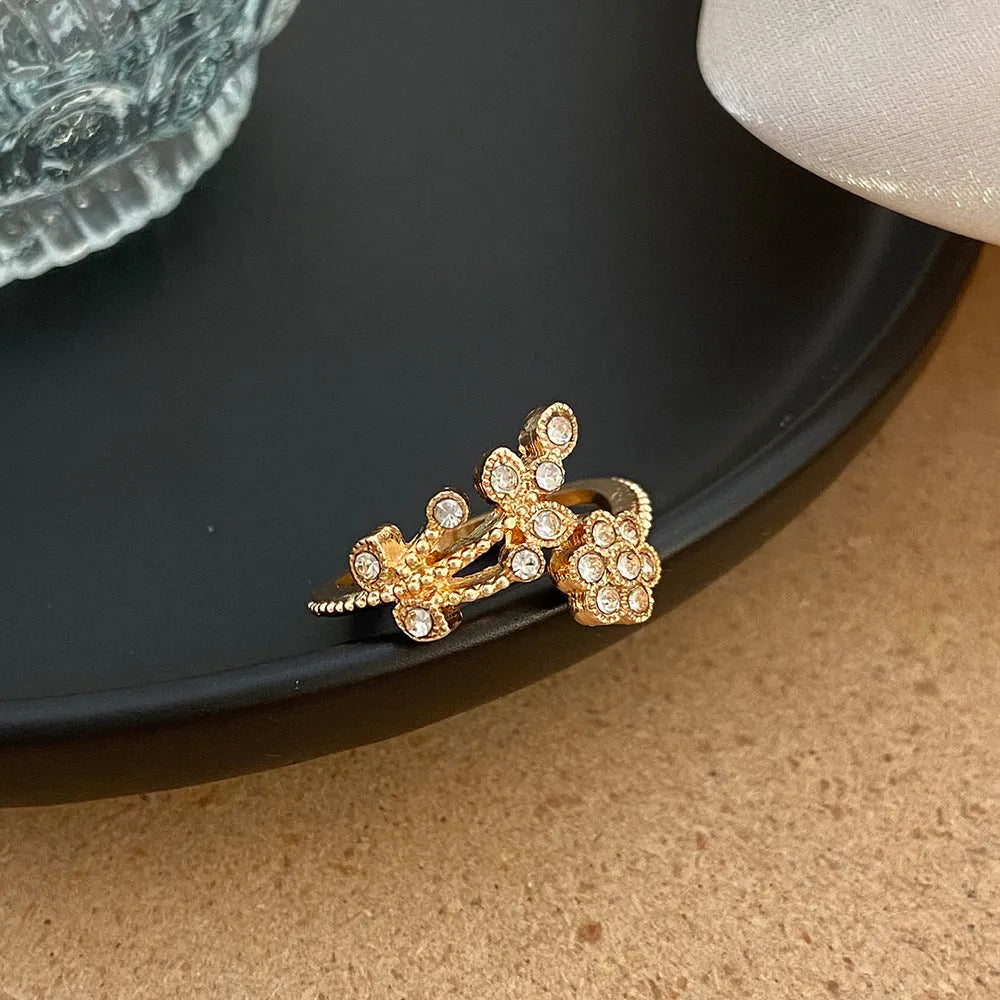Women's copper open ring with white and gold flower leaf design and diamond style finish