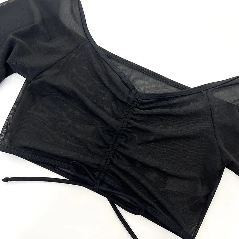 Black mesh long sleeve four-piece bikini set for women, laid flat showing top and briefs.