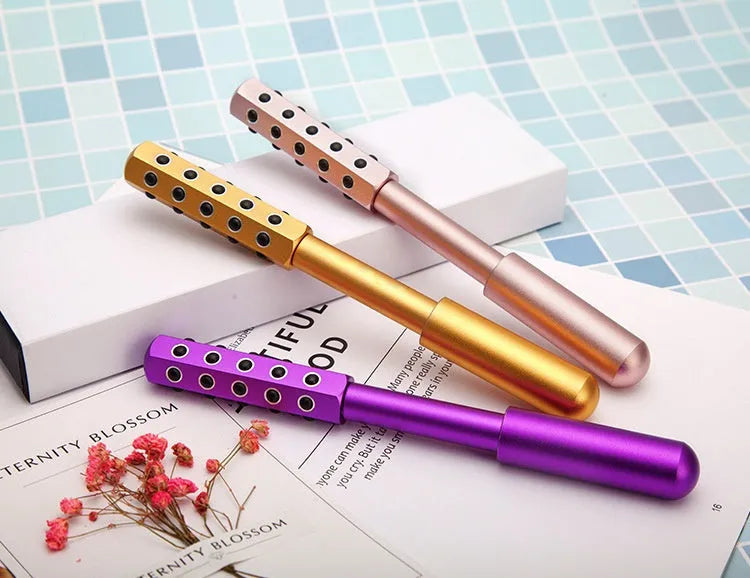 Purple handheld beauty massage roller with germanium particles for facial and eye care