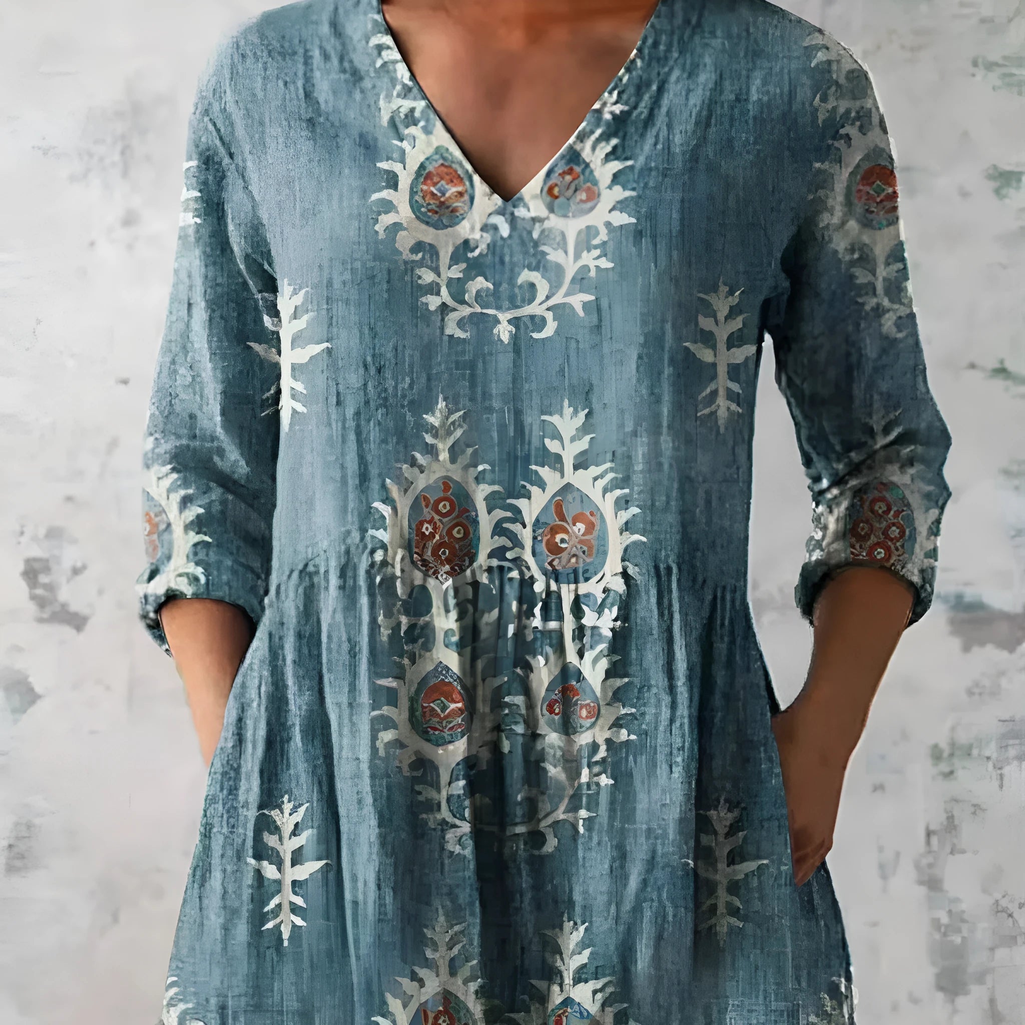 Women's printed loose-fitting dress with wide waist and three-quarter length sleeves.