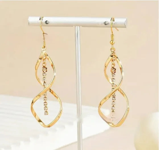 Gold spiral design diamond earrings with geometric shape and elliptical elements