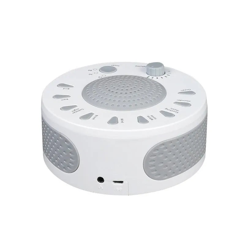 White noise sleep machine with volume knob, showing white colour option, beside USB cable on table