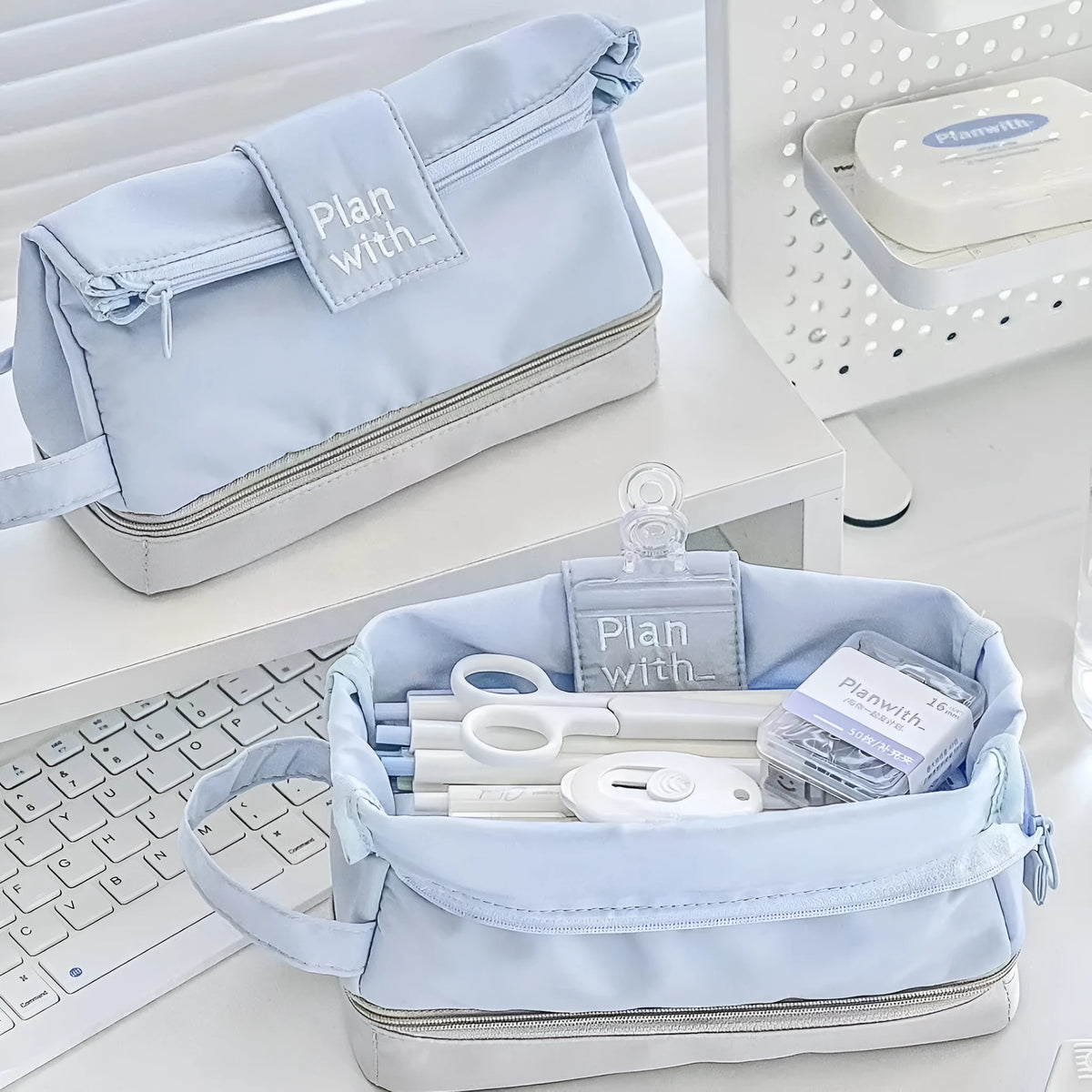 Folding double-layer student pencil case in polyester fabric, shown in dark blue, blue, and cream white colour options.