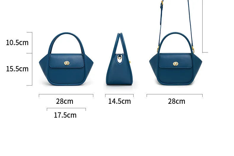 Women's winged leather handbag with cross-body strap in blue, showing latch closure and buckle detail.