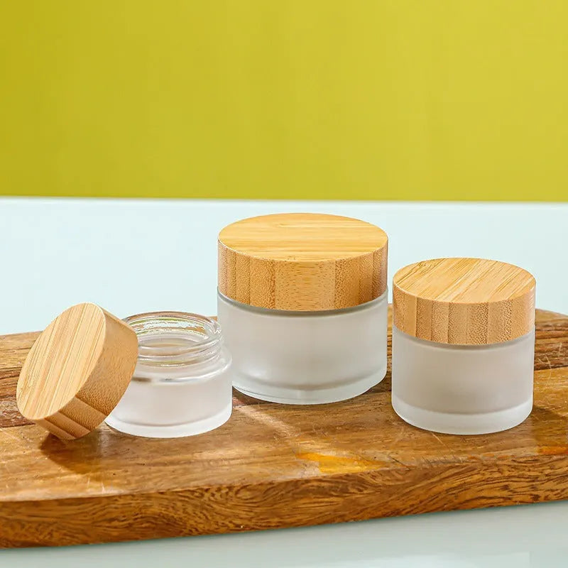 Bamboo wood cover frosted glass cream bottle with inner cushion, shown in transparent and frosted, 50g 60g 100g.