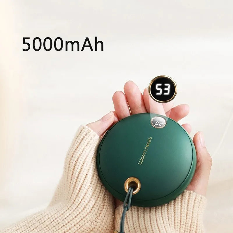 Green 5000mAh hand warmer power bank with digital display, shown next to its included USB charging cable.